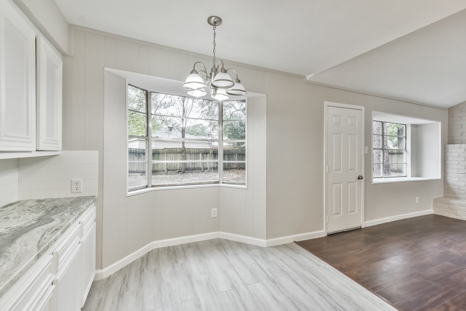 9718 John Bank Drive Spring, TX 77379 - Photo 17 of 39 a view of livingroom with chandelier and wooden floor