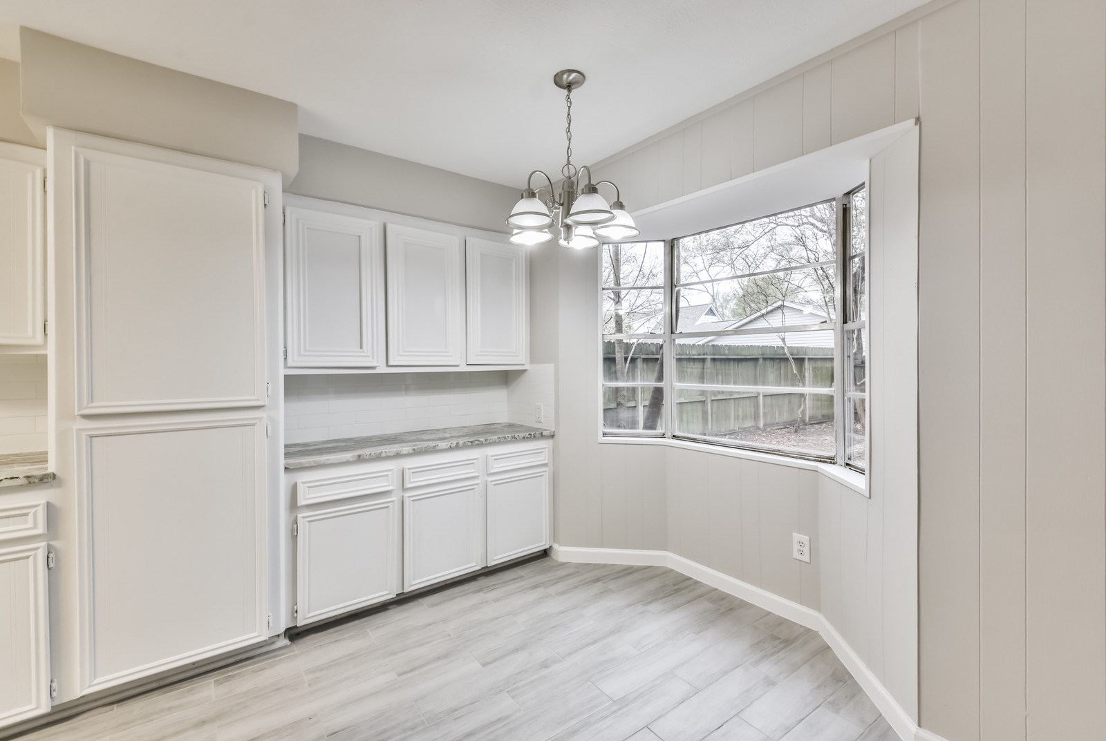 9718 John Bank Drive Spring, TX 77379 - Photo 18 of 39 a view of a kitchen with an empty space and a window
