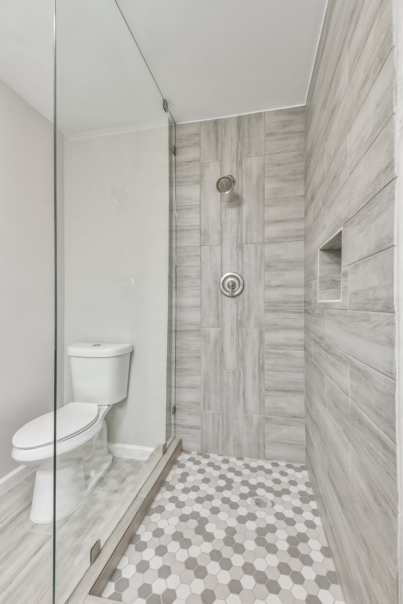 9718 John Bank Drive Spring, TX 77379 - Photo 23 of 39 a bathroom with a toilet and a shower