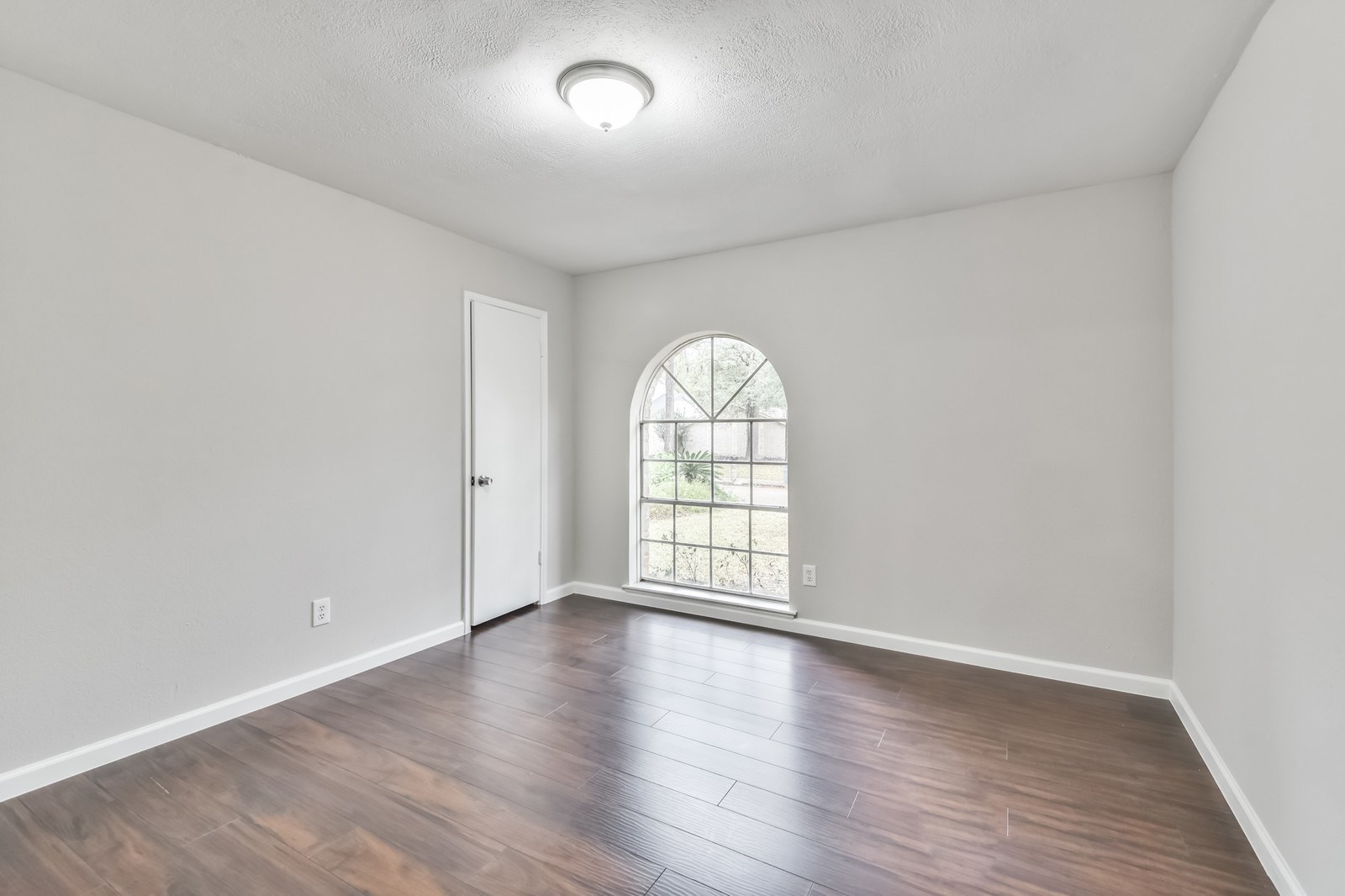 9718 John Bank Drive Spring, TX 77379 - Photo 26 of 39 an empty room with wooden floor and windows