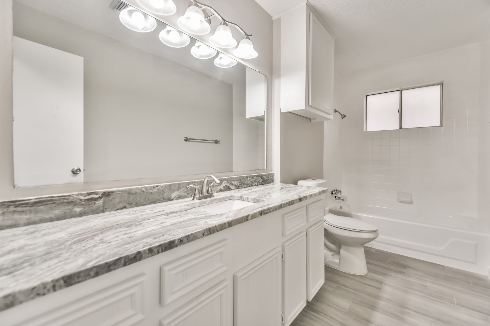 9718 John Bank Drive Spring, TX 77379 - Photo 28 of 39 a bathroom with a granite countertop sink a toilet and a mirror