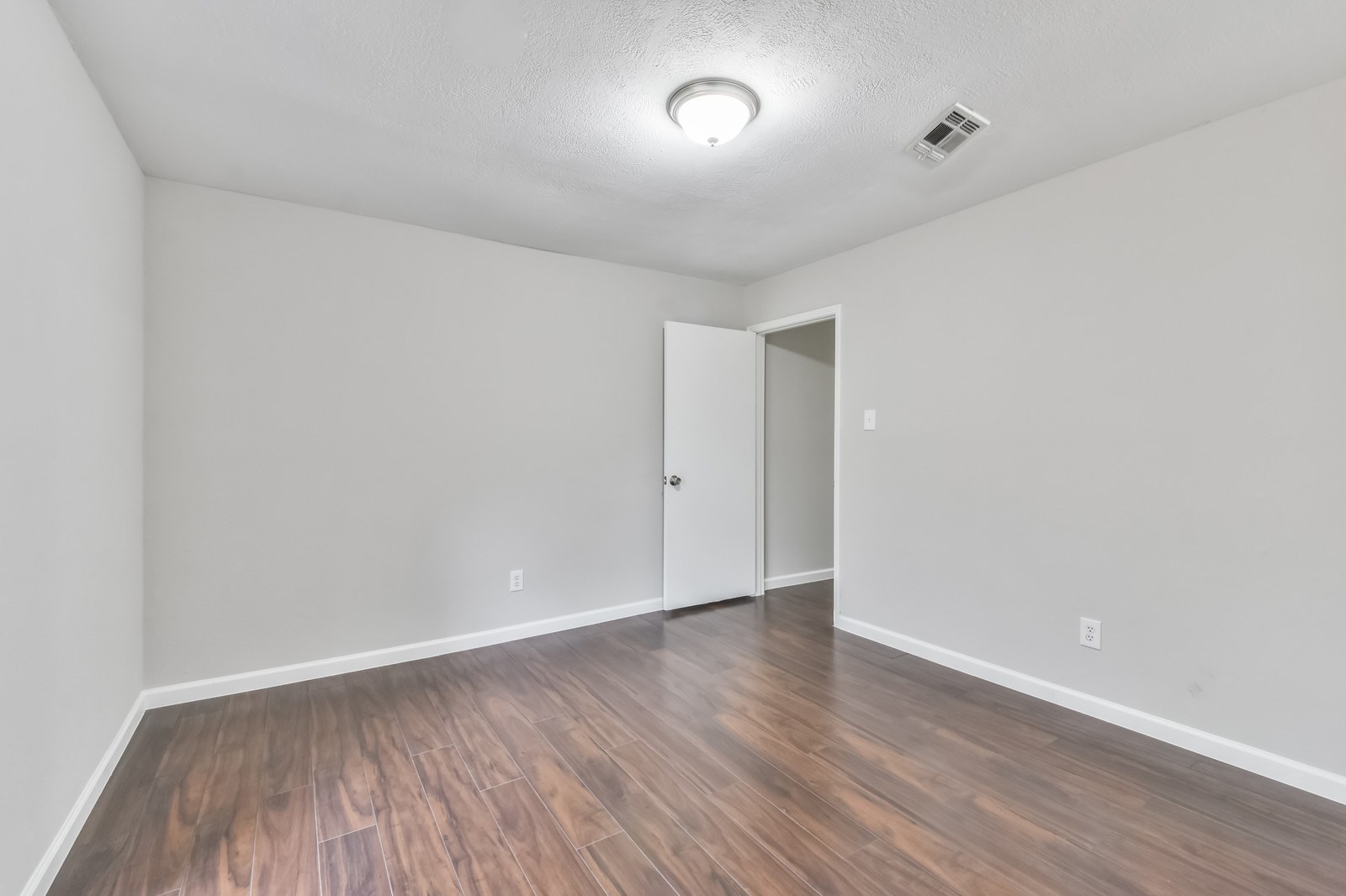 9718 John Bank Drive Spring, TX 77379 - Photo 29 of 39 a view of an empty room with wooden floor
