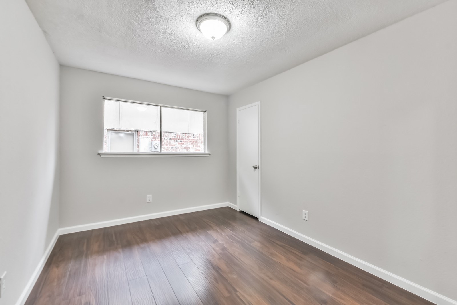 9718 John Bank Drive Spring, TX 77379 - Photo 30 of 39 an empty room with wooden floor and windows