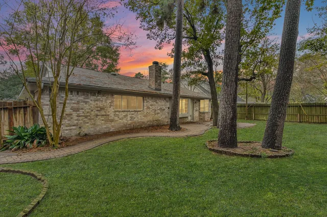 a view of a backyard with large trees