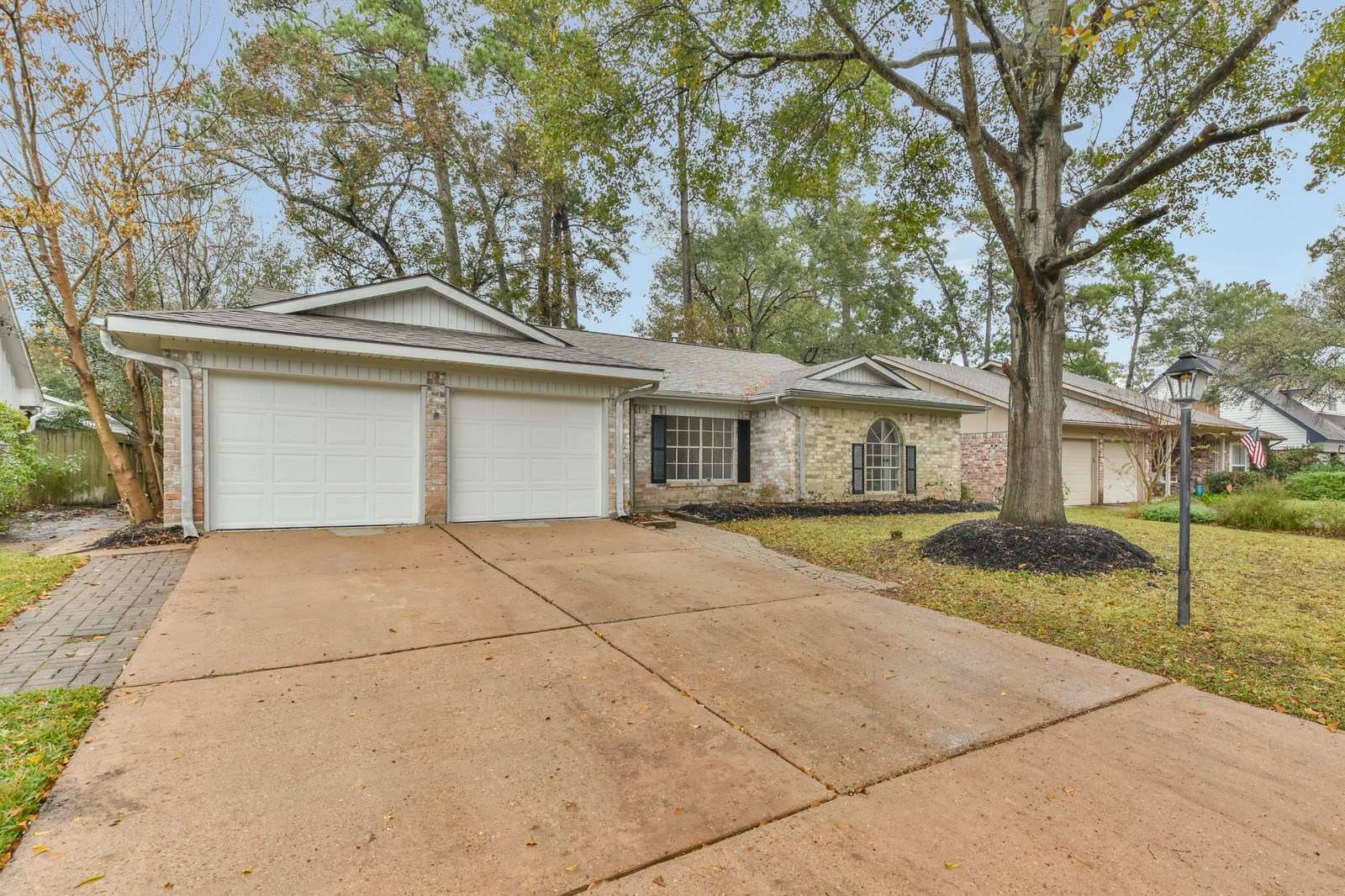 9718 John Bank Drive Spring, TX 77379 - Photo 35 of 39 a front view of a house with a yard and garage