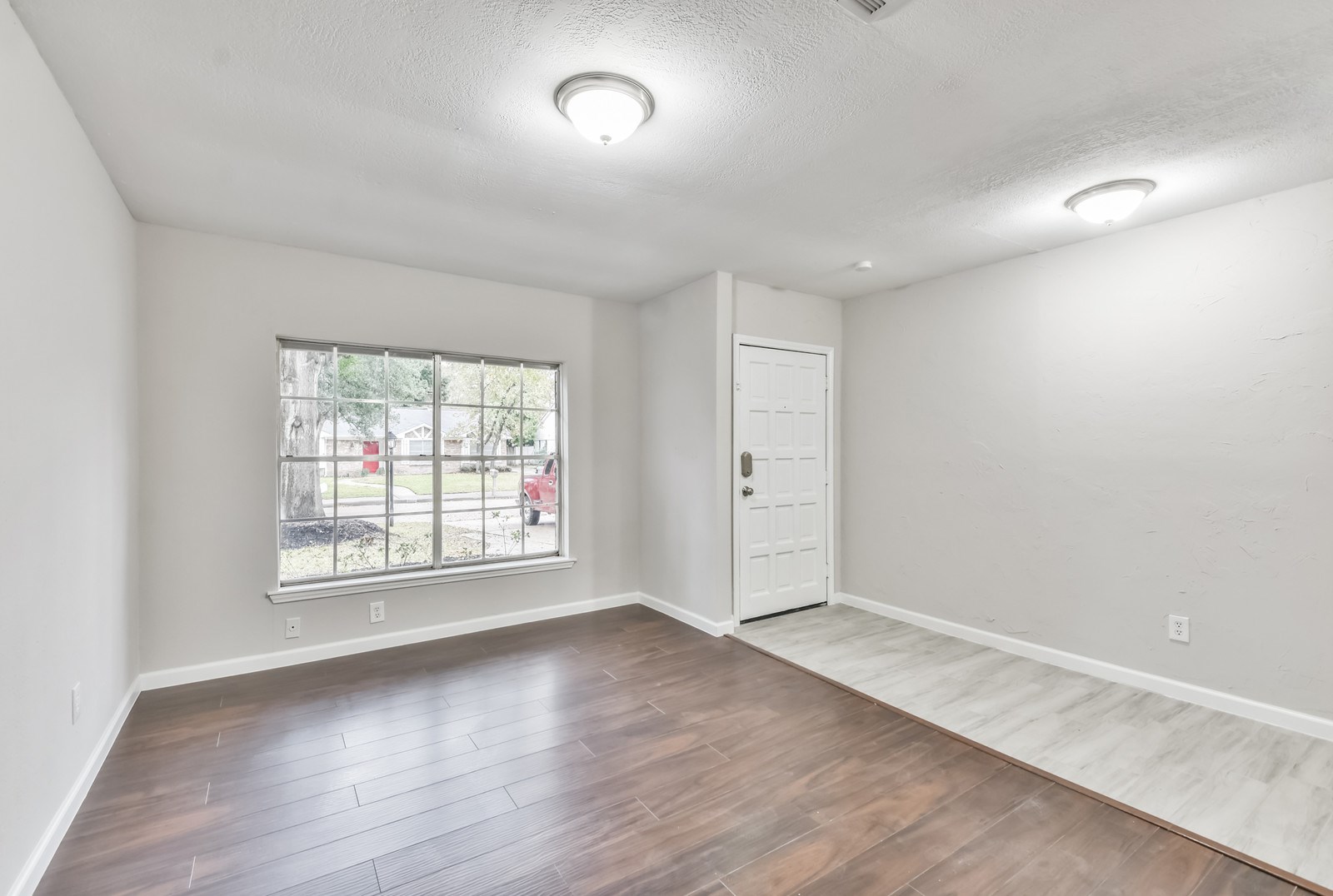 9718 John Bank Drive Spring, TX 77379 - Photo 5 of 39 an empty room with wooden floor and windows