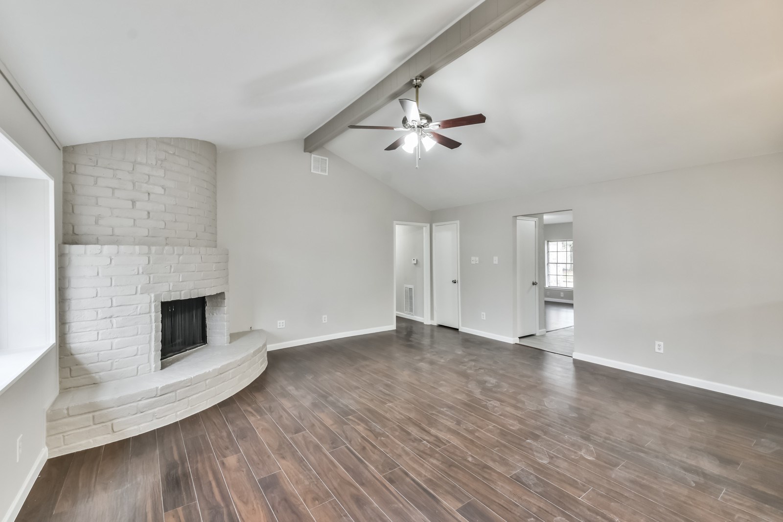 9718 John Bank Drive Spring, TX 77379 - Photo 10 of 39 a view of empty room with wooden floor and fireplace