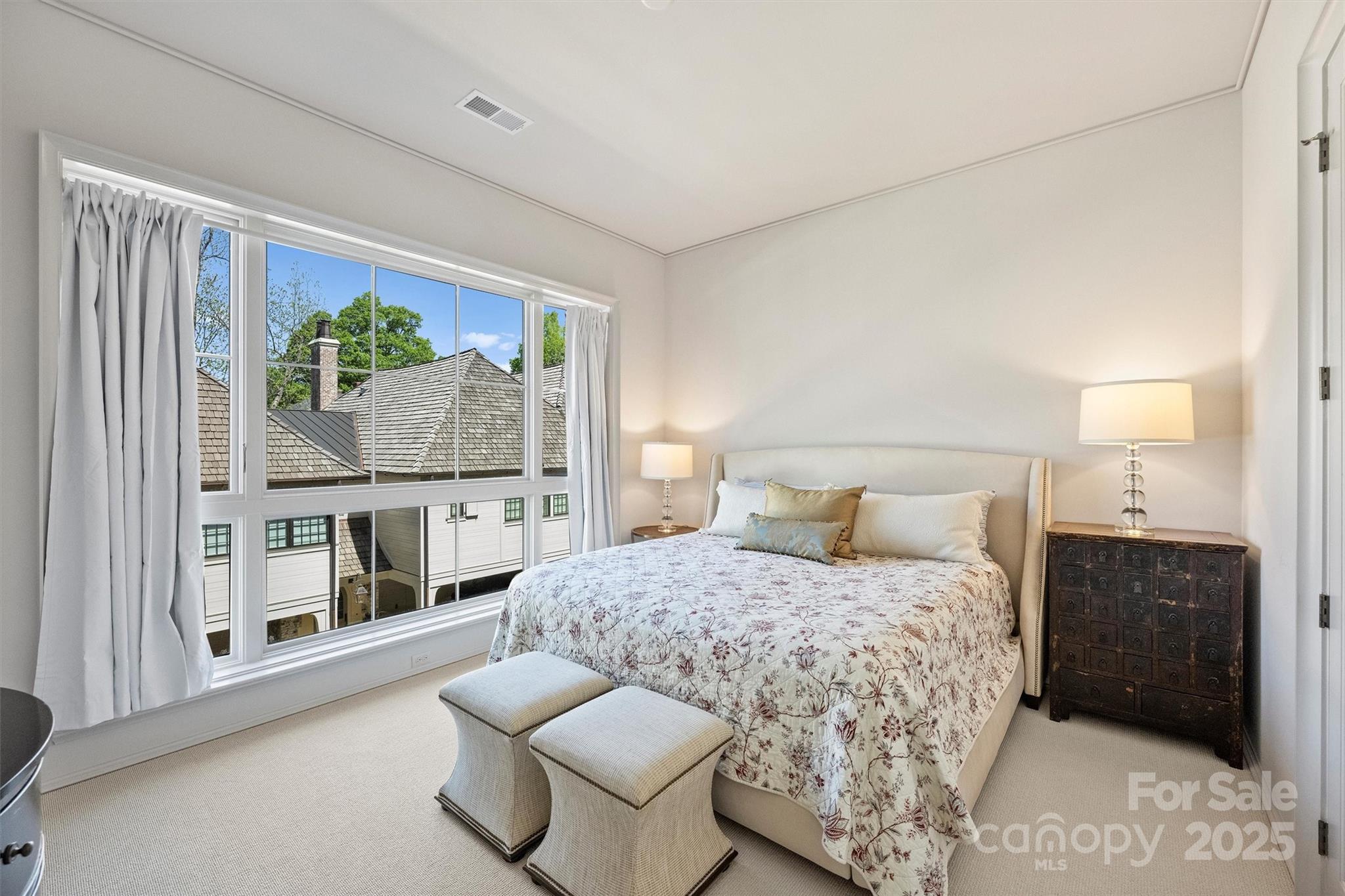 1170 Queens Road Charlotte, NC 28207 - Photo 19 of 29 a bedroom with a bed and a large window