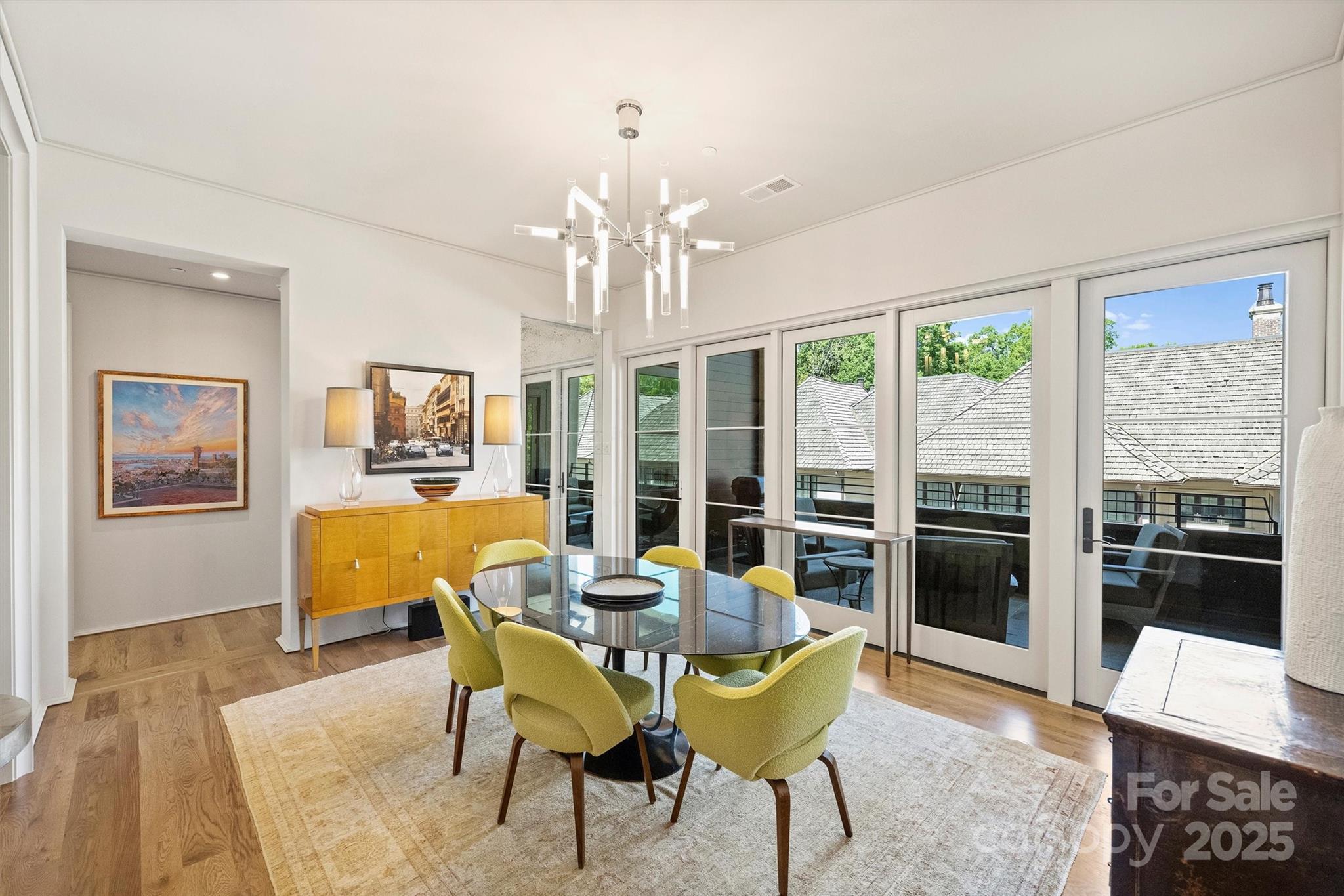 1170 Queens Road Charlotte, NC 28207 - Photo 7 of 29 a view of a dining room with furniture large window and wooden floor