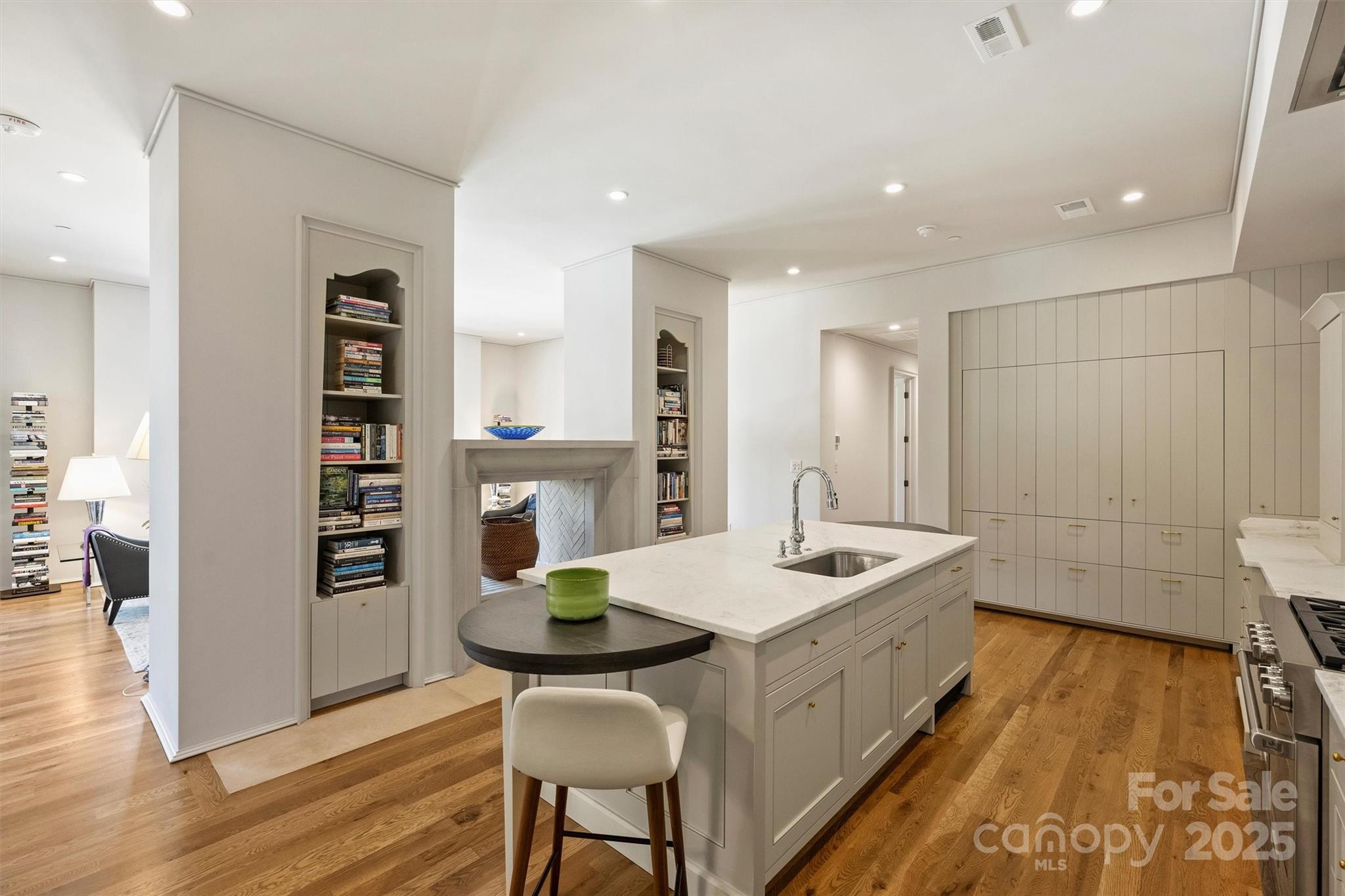 1170 Queens Road Charlotte, NC 28207 - Photo 9 of 29 a kitchen that has a sink a table and chairs in it