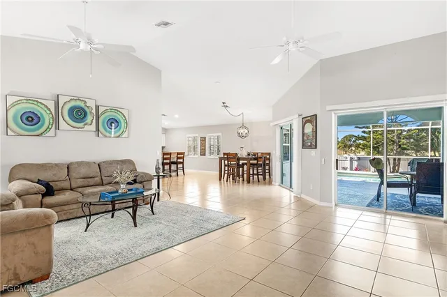 a living room with furniture and a table with wooden floor