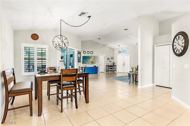 a view of a dining area with furniture and a large window