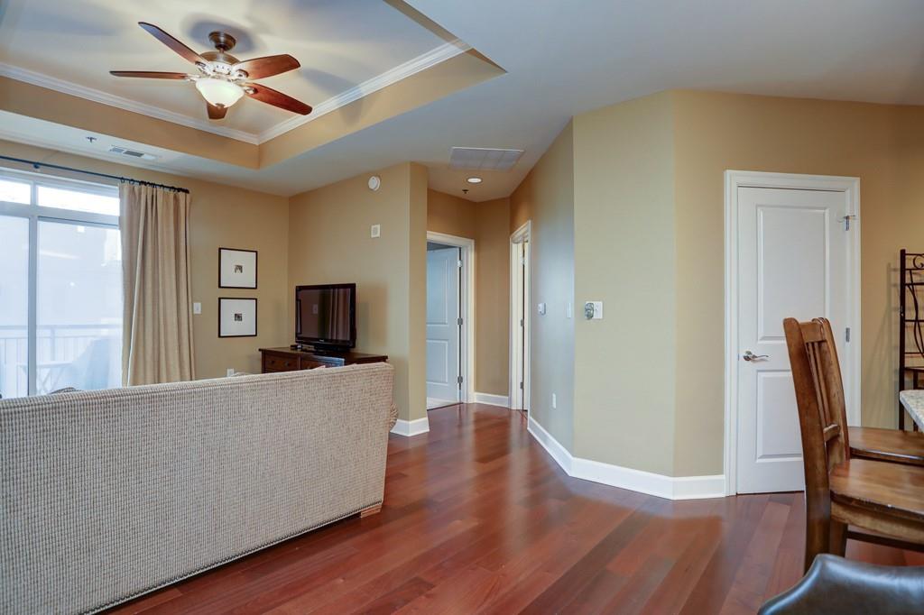 325 East Paces Ferry Road Northeast, Unit 1510 Atlanta, GA 30305 - Photo 12 of 33 a living room with furniture wooden floor and a ceiling fan