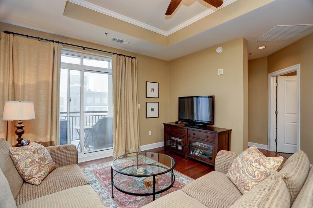 325 East Paces Ferry Road Northeast, Unit 1510 Atlanta, GA 30305 - Photo 13 of 33 a living room with furniture and a flat screen tv