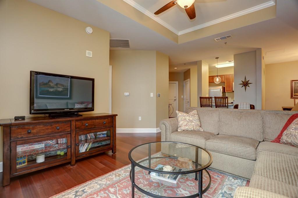 325 East Paces Ferry Road Northeast, Unit 1510 Atlanta, GA 30305 - Photo 15 of 33 a living room with furniture and a flat screen tv