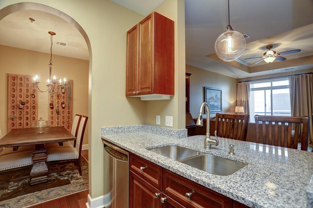 325 East Paces Ferry Road Northeast, Unit 1510 Atlanta, GA 30305 - Photo 16 of 33 a kitchen with granite countertop a sink a counter space appliances and cabinets