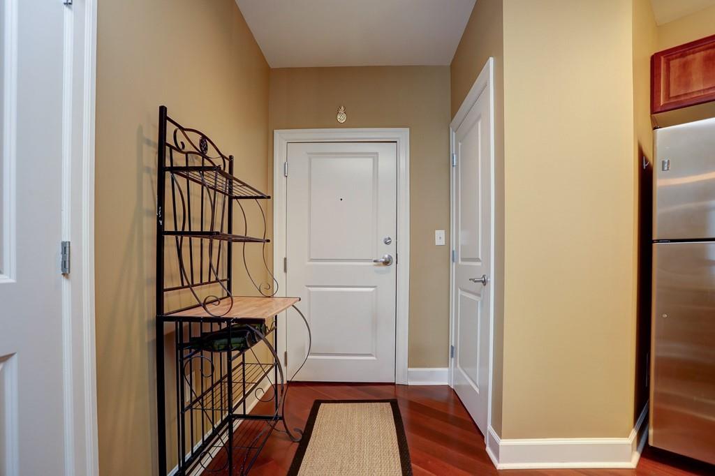 325 East Paces Ferry Road Northeast, Unit 1510 Atlanta, GA 30305 - Photo 17 of 33 a view of a hallway with wooden floor and dining room