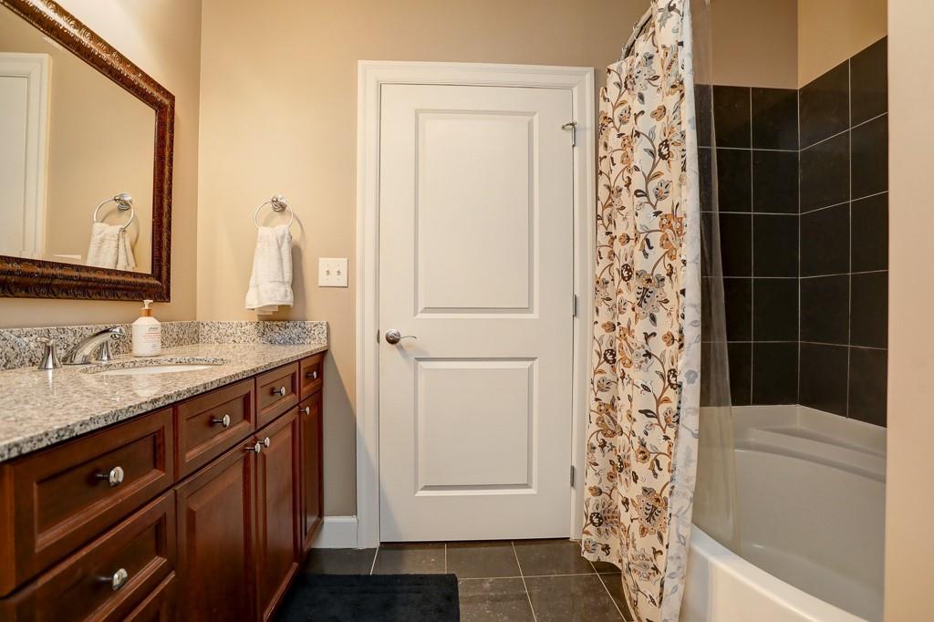 325 East Paces Ferry Road Northeast, Unit 1510 Atlanta, GA 30305 - Photo 21 of 33 a bathroom with a granite countertop sink a toilet and shower