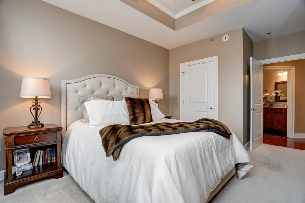 325 East Paces Ferry Road Northeast, Unit 1510 Atlanta, GA 30305 - Photo 23 of 33 a bedroom with bed and a night stand