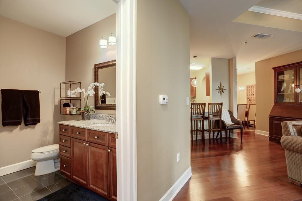 325 East Paces Ferry Road Northeast, Unit 1510 Atlanta, GA 30305 - Photo 25 of 33 a spacious bathroom with a granite countertop sink a toilet a mirror and a shower