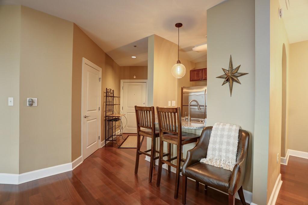 325 East Paces Ferry Road Northeast, Unit 1510 Atlanta, GA 30305 - Photo 3 of 33 a view of a dining room with furniture and wooden floor