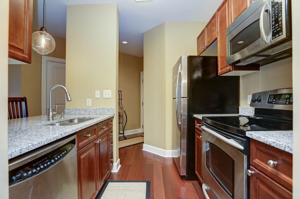 325 East Paces Ferry Road Northeast, Unit 1510 Atlanta, GA 30305 - Photo 7 of 33 a kitchen with stainless steel appliances granite countertop a sink a stove and a refrigerator