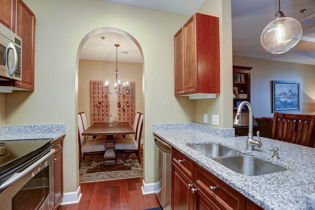 325 East Paces Ferry Road Northeast, Unit 1510 Atlanta, GA 30305 - Photo 8 of 33 a kitchen with granite countertop a sink a stove and cabinets