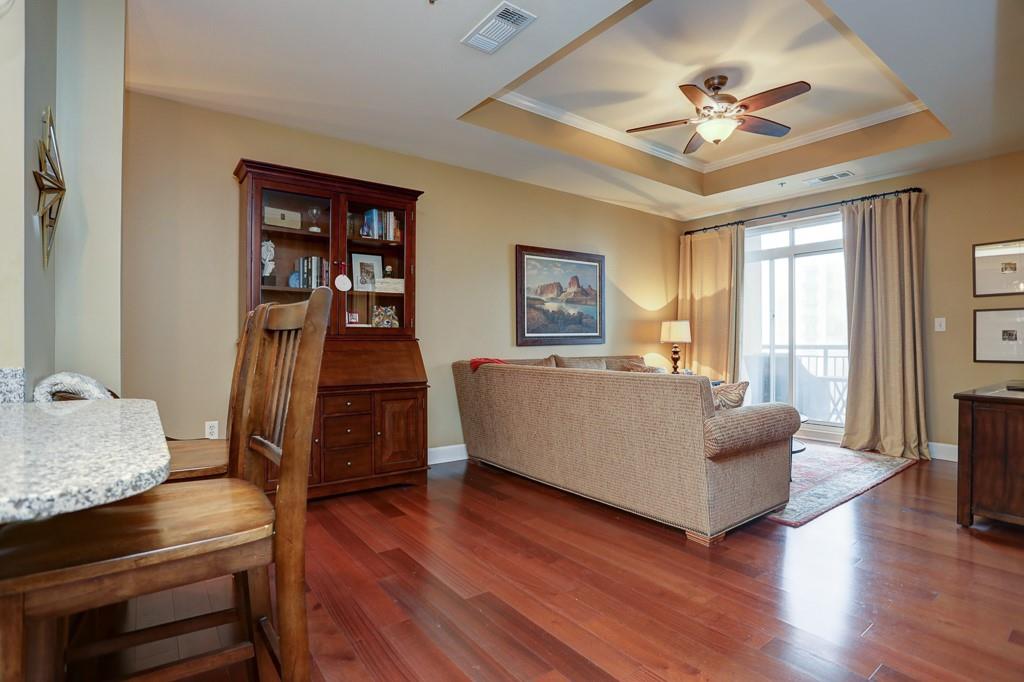 325 East Paces Ferry Road Northeast, Unit 1510 Atlanta, GA 30305 - Photo 9 of 33 a living room with furniture and a wooden floor