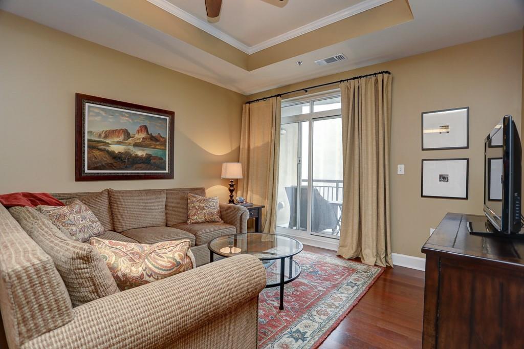 325 East Paces Ferry Road Northeast, Unit 1510 Atlanta, GA 30305 - Photo 10 of 33 a living room with furniture and a flat screen tv