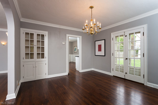 3615 Townley Road Beachwood, OH 44122 - Photo 4 of 13 View of the Formal Dining Room that opens through French Doors to a Stone Patio and Stone Garden Feature. The private backyard is fenced and ideal for gardening, family gatherings and pets. Built-In Cabinets and Crown Molding Deepen the room's character.