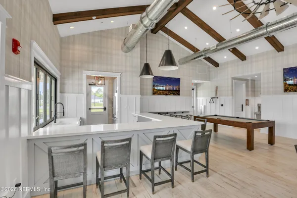 a kitchen with a table chairs refrigerator and cabinets