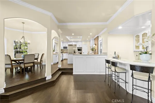 a kitchen with counter space dining table and chairs