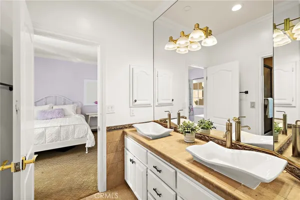 a bathroom with a granite countertop sink a large mirror and a bathtub