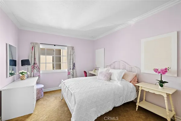 a bedroom with a bed couch and a window