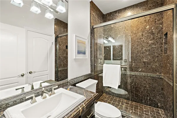 a bathroom with a sink toilet and shower