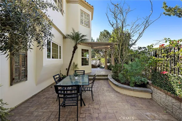 a view of a patio with table and chairs and potted plants