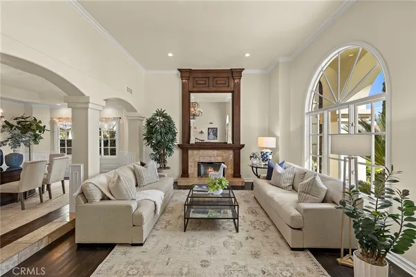 a living room with furniture a chandelier and a large window