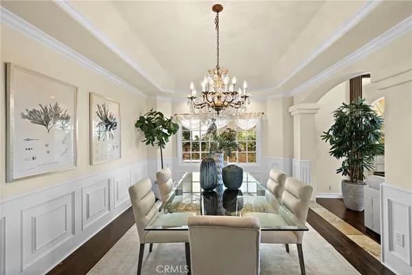 a dining room with furniture a chandelier and window