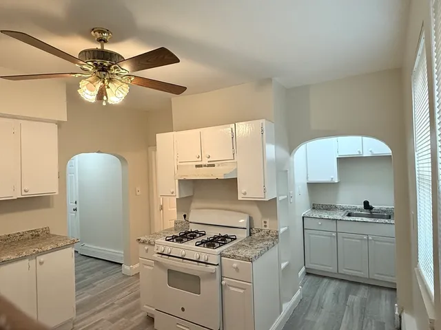 a kitchen with a stove a sink and a refrigerator
