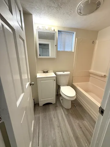 a bathroom with a toilet a sink and a bathtub