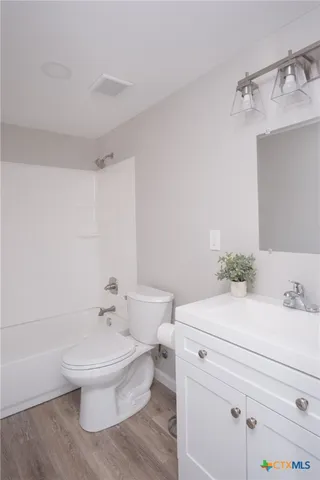 a bathroom with a sink a toilet and a bathtub