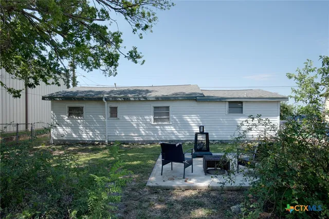 a front view of house with yard and outdoor seating