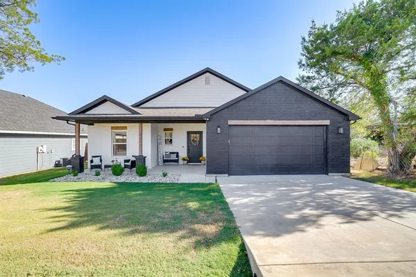 a front view of a house with yard and green space
