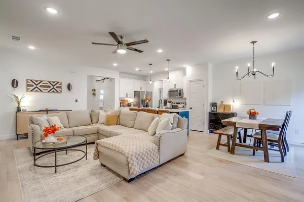 a living room with furniture and kitchen view