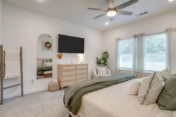 a bedroom with a bed and a flat screen tv