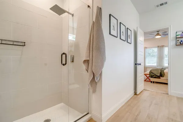 a bathroom with a sink a mirror and shower