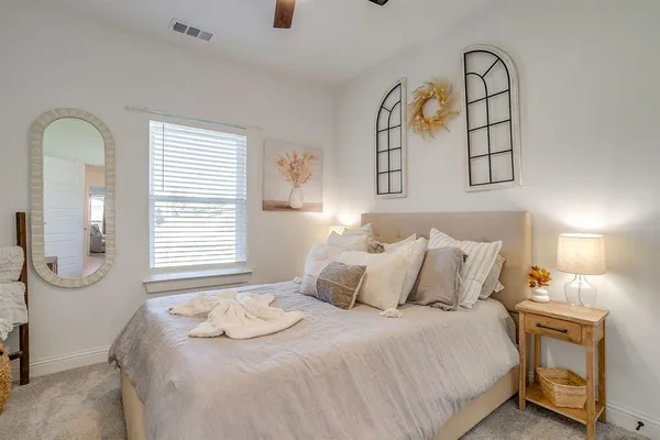 a bedroom with a bed and a window