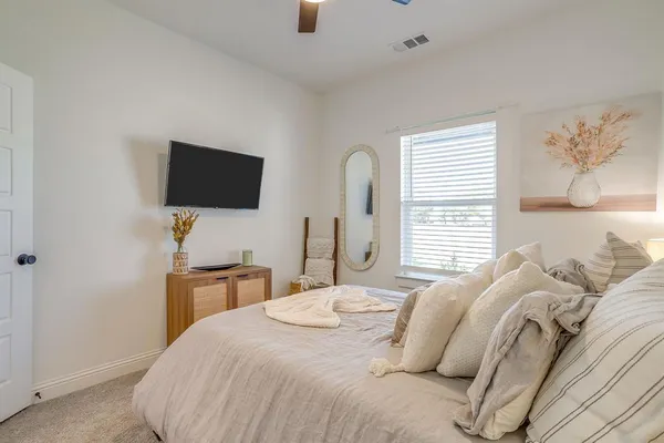 a bedroom with a bed and a flat screen tv