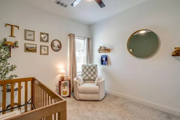 a living room with furniture and a mirror