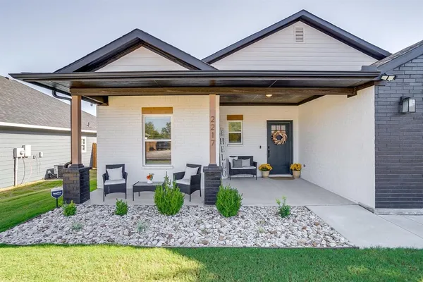 a front view of a house with garden